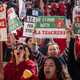 Educators, parents, students, and supporters of the Los Angeles teachers strike wave and cheer in Grand Park on January 22, 2019 in downtown Los Angeles, California.